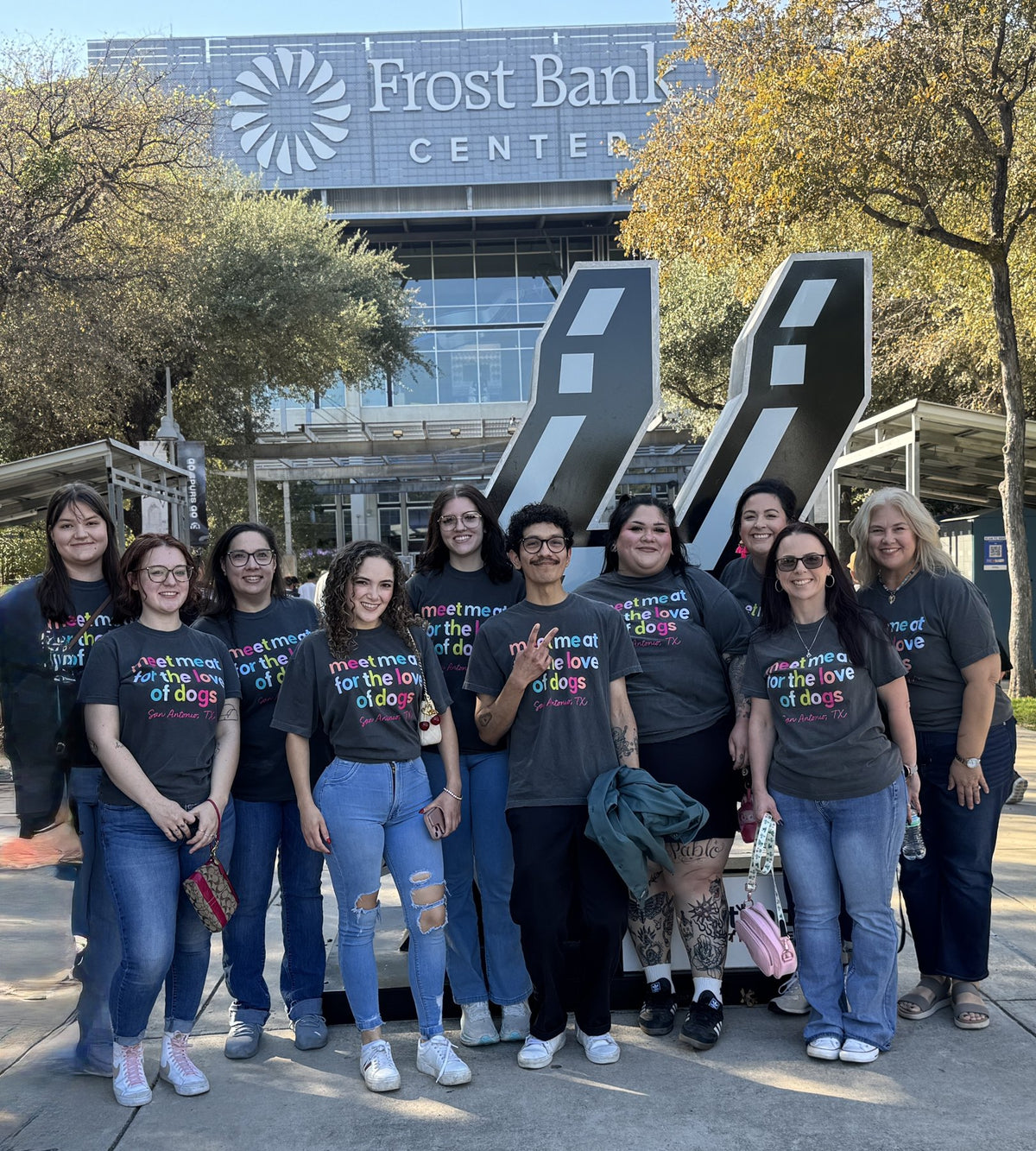 A group wearing For the Love of Dogs shirts outside Frost Bank Center